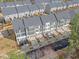 Aerial view of modern townhome community with gray roofs and well-maintained landscaping at 1207 Corkery Ridge Ct, Cary, NC 27519