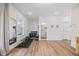 Finished basement with exercise equipment, hardwood floors, and view to a bathroom at 1207 Corkery Ridge Ct, Cary, NC 27519