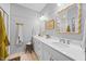 Bright bathroom featuring double sink vanity with white cabinets, framed mirrors, and modern lighting at 1207 Corkery Ridge Ct, Cary, NC 27519