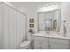 Bright bathroom with a white shower curtain, vanity, toilet, and neutral wall colors at 1207 Corkery Ridge Ct, Cary, NC 27519