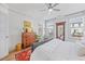 Bedroom features wood floors, neutral walls, multiple windows, a dresser, and a comfortable bed at 1207 Corkery Ridge Ct, Cary, NC 27519