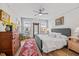 Bright bedroom with wood floors, neutral walls, a ceiling fan, and multiple windows for natural light at 1207 Corkery Ridge Ct, Cary, NC 27519