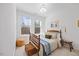 Bright bedroom features a wood frame bed with storage basket, a window, and hardwood floors at 1207 Corkery Ridge Ct, Cary, NC 27519