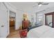 Bright bedroom with wood floors, neutral walls, multiple windows, a dresser, and a comfortable bed at 1207 Corkery Ridge Ct, Cary, NC 27519