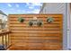 Cozy backyard deck with a decorative screen and hanging potted plants creating a relaxing outdoor space at 1207 Corkery Ridge Ct, Cary, NC 27519