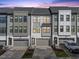 Charming townhome showcases a contemporary design with a two-car garage, and a gray and white color scheme at 1207 Corkery Ridge Ct, Cary, NC 27519