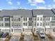 View of townhomes featuring a modern design with two car garages and neat landscaping, perfect for convenient living at 1207 Corkery Ridge Ct, Cary, NC 27519