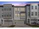 Stylish townhome complex with mixed materials, showcasing attached garages and modern design at 1207 Corkery Ridge Ct, Cary, NC 27519
