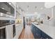 Bright kitchen features an island with sink, stainless steel appliances, gas cooktop, and modern pendant lighting at 1207 Corkery Ridge Ct, Cary, NC 27519