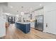 Bright open kitchen features stainless steel appliances, large center island and views to the living room at 1207 Corkery Ridge Ct, Cary, NC 27519