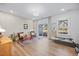 Spacious room with hardwood floors, a rug, and plenty of light coming in from the sliding glass door at 1207 Corkery Ridge Ct, Cary, NC 27519
