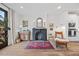 Stylish living room with decorative fireplace, wood floors, a unique mirror, and comfortable seating arrangements at 1207 Corkery Ridge Ct, Cary, NC 27519