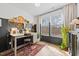 Office room with a wooden desk, a rug, and a large window with plants adding brightness to the area at 1207 Corkery Ridge Ct, Cary, NC 27519
