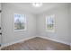 Spacious bedroom with hardwood floors, bright windows and neutral walls at 1208 Goldsboro Ave, Sanford, NC 27330