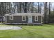 Charming single-story home featuring a light-blue front door, well-manicured lawn, and mature trees at 1208 Goldsboro Ave, Sanford, NC 27330