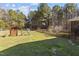 Picturesque backyard featuring a well-maintained lawn, mature trees, and a charming fence at 1324 Emerson Cook Rd, Pittsboro, NC 27312