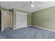 Bedroom featuring neutral walls, blue carpet, and a ceiling fan with light fixture at 1324 Emerson Cook Rd, Pittsboro, NC 27312