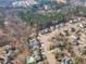 A community aerial view showing mature trees, residential homes, streets and a community pool at 1416 Endgame Ct, Wake Forest, NC 27587