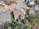 An aerial view of the backyard showing a deck and chairs, mature trees and a neighboring home at 1416 Endgame Ct, Wake Forest, NC 27587
