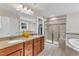 Well-lit bathroom with double vanity, granite countertops, soaking tub, and tiled walk-in shower with glass doors at 1416 Endgame Ct, Wake Forest, NC 27587