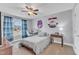 Cozy bedroom featuring a large window, carpeted floors, a ceiling fan, and neutral decor at 1416 Endgame Ct, Wake Forest, NC 27587