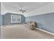 Spacious bonus room features neutral carpet, fan, a tan couch, and natural light from large window at 1416 Endgame Ct, Wake Forest, NC 27587
