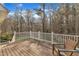 Deck overlooking wooded backyard with seating at 1416 Endgame Ct, Wake Forest, NC 27587