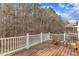 Deck overlooking wooded backyard with seating and small table at 1416 Endgame Ct, Wake Forest, NC 27587