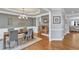 Beautiful dining room with a modern chandelier, wainscoting, and an open view into the living room at 1416 Endgame Ct, Wake Forest, NC 27587