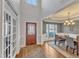 Elegant foyer with hardwood floors, a beautiful front door, and an open view into the dining room at 1416 Endgame Ct, Wake Forest, NC 27587