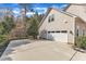 A spacious garage with a concrete driveway and landscaping at 1416 Endgame Ct, Wake Forest, NC 27587
