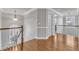 Second floor hall area with hardwood floors, white trim, and a decorative light fixture at 1416 Endgame Ct, Wake Forest, NC 27587