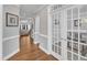 Open hallway with hardwood floors, arched doorways, and a view into the living room at 1416 Endgame Ct, Wake Forest, NC 27587