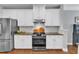 Charming kitchen features white cabinetry, stainless steel appliances, and granite countertops at 1416 Endgame Ct, Wake Forest, NC 27587