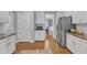 Modern kitchen features white cabinetry, stainless steel refrigerator, and hardwood floors at 1416 Endgame Ct, Wake Forest, NC 27587