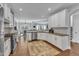 Open kitchen with white cabinets, stainless appliances, and eat-in dining area at 1416 Endgame Ct, Wake Forest, NC 27587
