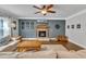 Inviting living room featuring a stone fireplace, ceiling fan, and hardwood floors at 1416 Endgame Ct, Wake Forest, NC 27587