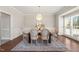 Elegant dining room with a chandelier, hardwood floors, large windows, and seating for six at 1708 Turtle Ridge Way, Raleigh, NC 27614