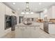 Bright kitchen with an island cooktop, stainless steel appliances, and custom cabinetry at 1708 Turtle Ridge Way, Raleigh, NC 27614