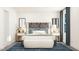 Serene bedroom with a king-sized bed, stylish headboard, and matching nightstands with elegant lamps at 1755 Barrett Run Trl # 213, Apex, NC 27502