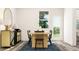 Charming dining room featuring a wooden table with black chairs, complemented by stylish decor and natural light at 1755 Barrett Run Trl # 213, Apex, NC 27502