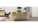 Modern kitchen featuring white cabinetry, stainless steel appliances, and bar seating at the center island at 1755 Barrett Run Trl # 213, Apex, NC 27502