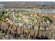 Aerial view showcases a neighborhood with mature trees and well-kept lawns during the early spring at 1818 Buxton Way, Burlington, NC 27215