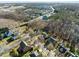 An elevated aerial view of a tree lined neighborhood with access to highways in the distance at 1818 Buxton Way, Burlington, NC 27215