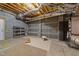 Unfinished basement featuring exposed ductwork, concrete walls, and shelving units for storage at 1818 Buxton Way, Burlington, NC 27215