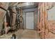 Unfinished basement showing exposed mechanicals, insulation, concrete walls, and a utility door at 1818 Buxton Way, Burlington, NC 27215
