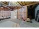 Unfinished basement featuring exposed ductwork, insulation, concrete walls, and bare floors at 1818 Buxton Way, Burlington, NC 27215