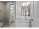 Bathroom showcasing a white vanity with ample storage, a large mirror, and a second bathroom in view at 1818 Buxton Way, Burlington, NC 27215