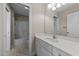 Bright bathroom featuring a white vanity, a well-lit mirror, and a shower-tub combo for a functional design at 1818 Buxton Way, Burlington, NC 27215