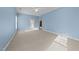 Bedroom featuring light blue walls, carpet, and a back door to the patio at 1818 Buxton Way, Burlington, NC 27215